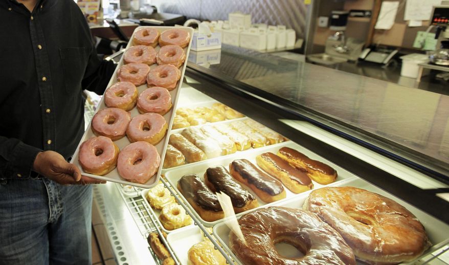FILE - In this April 26, 2011 file photo, doughnuts are displayed in Chicago. There are a lot fewer trans fats in the nation’s food than there were a decade ago, but the Obama administration is moving toward getting rid of them almost entirely. The Food and Drug Administration says Americans still eat about a gram of trans fat every day, and phasing it out could prevent 20,000 heart attacks and 7,000 deaths each year. (AP Photo/M. Spencer Green, File)