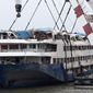 In this Sunday, June 7, 2015 photo, rescuers work on the raised capsized ship Eastern Star on the Yangtze River in Jianli county of southern Chinas Hubei province. China has assembled a 60-strong team to probe last week&#39;s river cruise ship sinking following orders from President Xi Jinping to find the cause of the country&#39;s worst maritime disaster in nearly seven decades. (AP Photo/Andy Wong)
