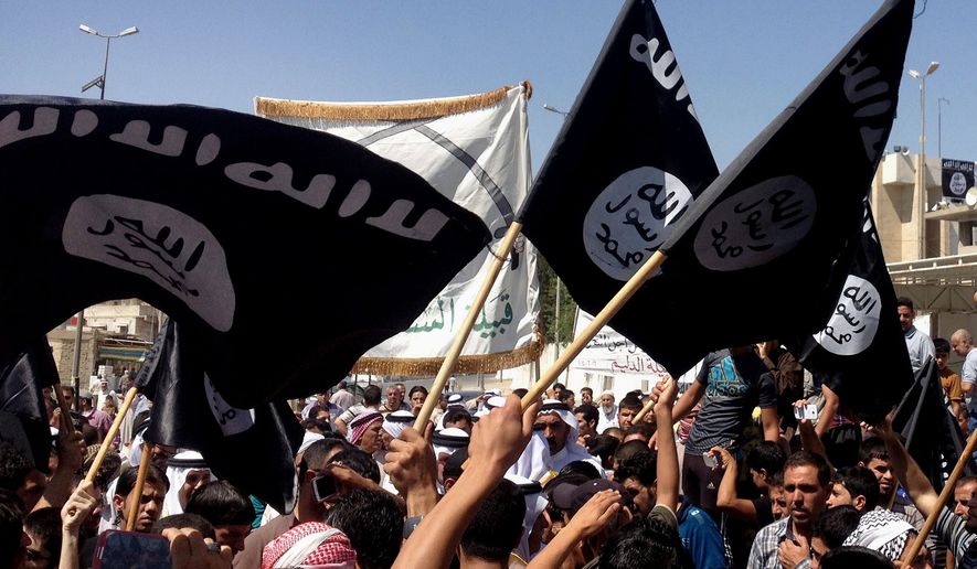 Demonstrators chant pro-Islamic State group slogans as they wave the group&#39;s flags in front of the provincial government headquarters in Mosul, Iraq, in this Monday, June 16, 2014, file photo. (AP Photo, File)