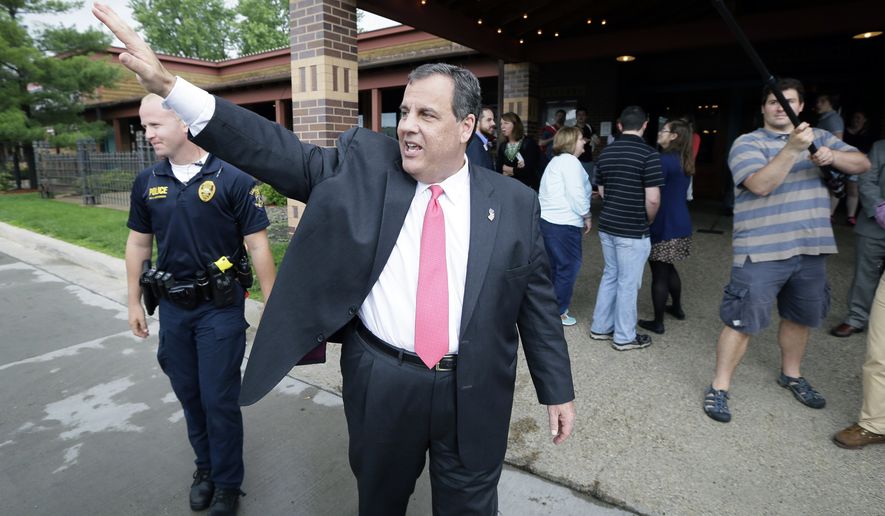 New Jersey Gov. Chris Christie waves to supporters after visiting with customers at the Hickory Park Restaurant, Thursday, June 11, 2015, in Ames, Iowa. (AP Photo/Charlie Neibergall)