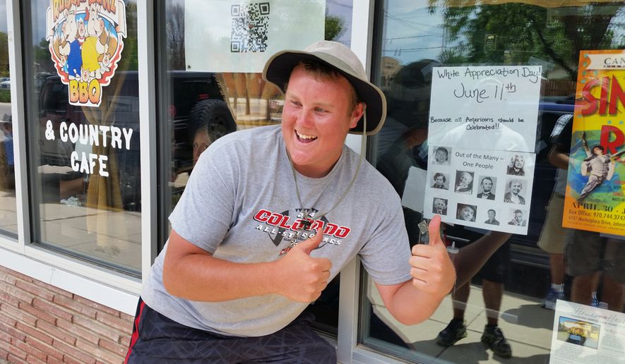 Ryan Flynn of Johnstown, Colorado, poses next to the &quot;White Appreciation Day&quot; poster outside Rubbin Buttz BBQ in Milliken, Colorado. (Valerie Richardson/The Washington Times)