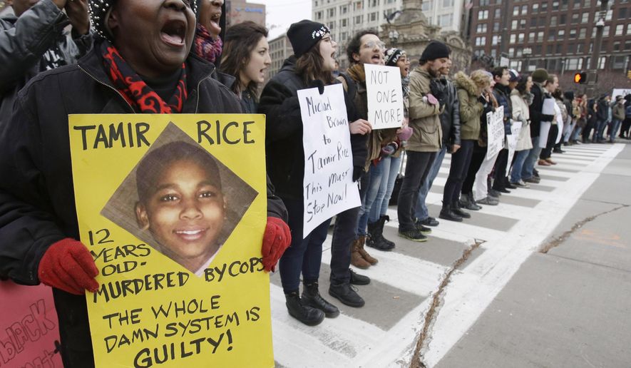 FILE- In this Nov. 25, 2014, file photo, demonstrators block Public Square in Cleveland, during a protest over the police shooting of 12-year-old Tamir Rice. A judge has ruled that evidence exists to charge two police officers in the fatal shooting of a 12-year-old boy who was holding a pellet gun outside a recreation center, Thursday, June 11, 2015. (AP Photo/Tony Dejak, File)