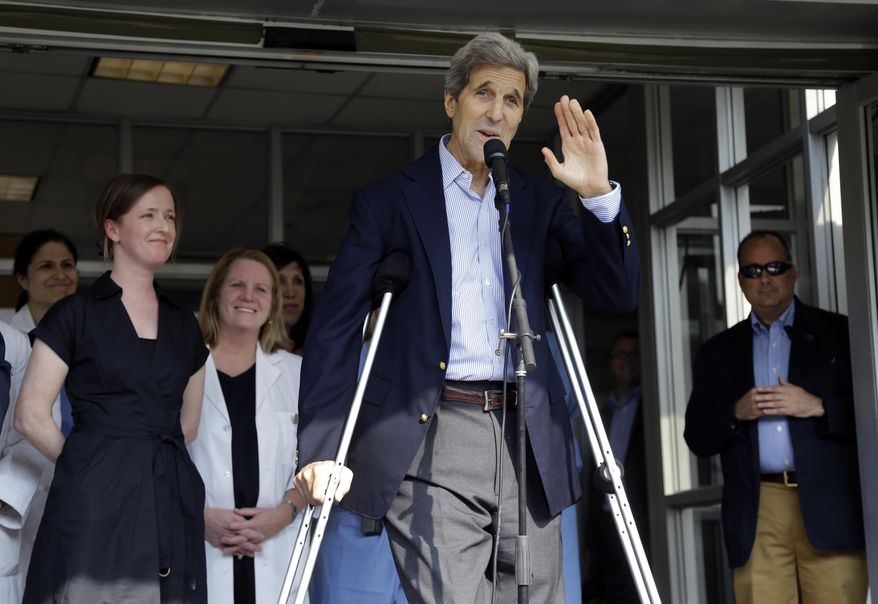 Secretary of State John Kerry waves after speaking to media as he is discharged from Massachusetts General Hospital Friday, June 12, 2015, in Boston. Kerry was released from the hospital after undergoing surgery on a broken leg sustained in a May 31 bicycle accident in France. (AP Photo/Elise Amendola)