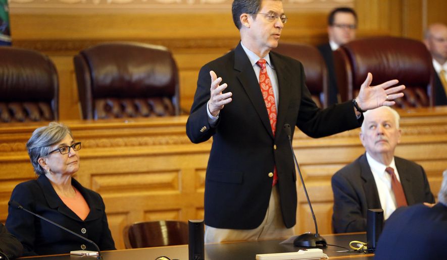 Kansas Gov. Sam Brownback addresses a joint caucus of the Kansas Senate and House republicans, Thursday, June 11, 2015 in Topeka, Kan. Kansas faced the prospect of deep cuts to schools, prisons and other programs after the Republican-controlled House soundly rejected a proposal supported by Brownback that would hike sales and cigarette taxes to close a budget deficit. (Bo Rader/The Wichita Eagle via AP) LOCAL STATIONS OUT; MAGS OUT; LOCAL RADIO OUT; LOCAL INTERNET OUT
