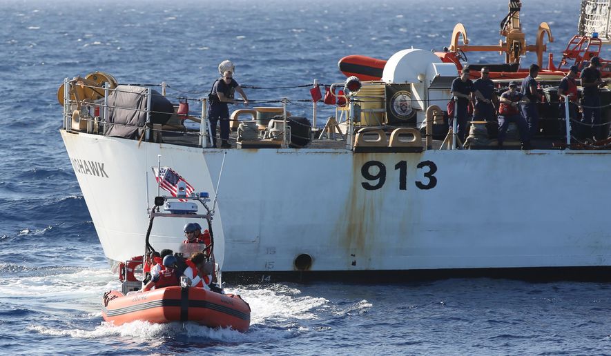 In this photo taken in the Florida Straits on May 17, 2015, members of the U.S. Coast Guard Cutter Charles David Jr, foreground, leaving the USCG cutter Mohawk with six Cuban migrants. U.S. authorities have captured or intercepted more than 2,500 Cuban migrants attempting the risky sea crossing from Cuba to the U.S. since Oct. 1, 2014. (AP Photo/Tony Winton)