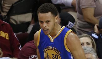 Golden State Warriors guard Stephen Curry (30) reacts during the second half of Game 4 of basketball&#39;s NBA Finals against the Cleveland Cavaliers, in Cleveland, Thursday, June 11, 2015. (AP Photo/Paul Sancya)