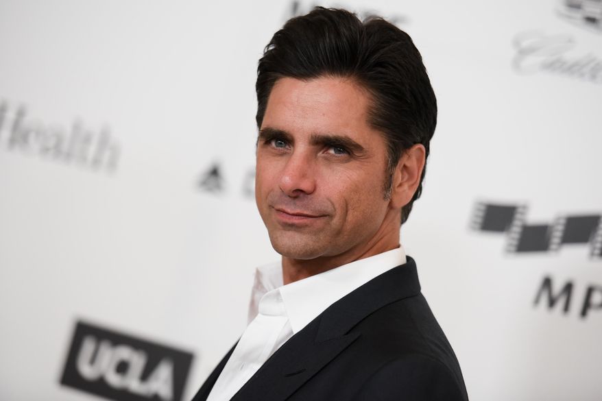 Actor John Stamos arrives at the 4th Annual Reel Stories, Real Lives Benefit in Los Angeles, April 25, 2015. (Associated Press) ** FILE **