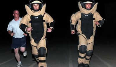 U.S. airmen run in bomb suits on Sept. 12, 2009, while deployed to Kirkuk, Iraq. (Image: U.S. Air Force) ** FILE **