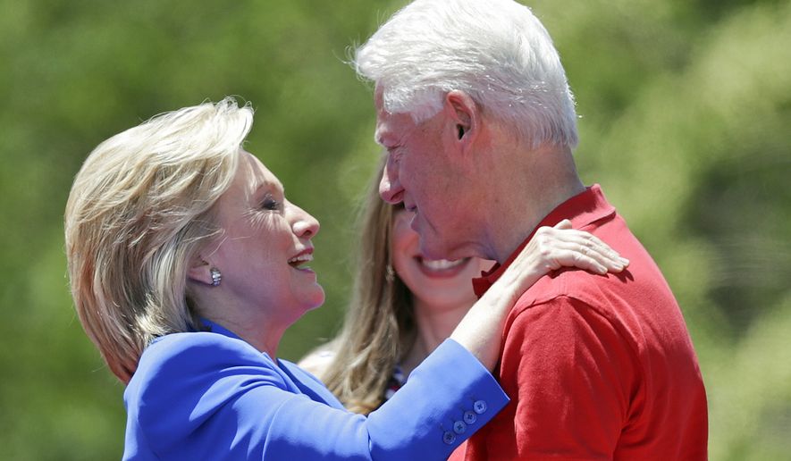 Democratic presidential candidate, former Secretary of State Hillary Rodham Clinton, left, hugs her husband former President Bill Clinton after speaking to supporters Saturday, June 13, 2015, on Roosevelt Island in New York.  (AP Photo/Frank Franklin II)