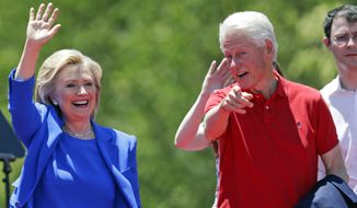 Democratic presidential candidate, former Secretary of State Hillary Rodham Clinton, and former President Bill Clinton, right gesture to supporters Saturday, June 13, 2015, on Roosevelt Island in New York.  (AP Photo/Frank Franklin II)