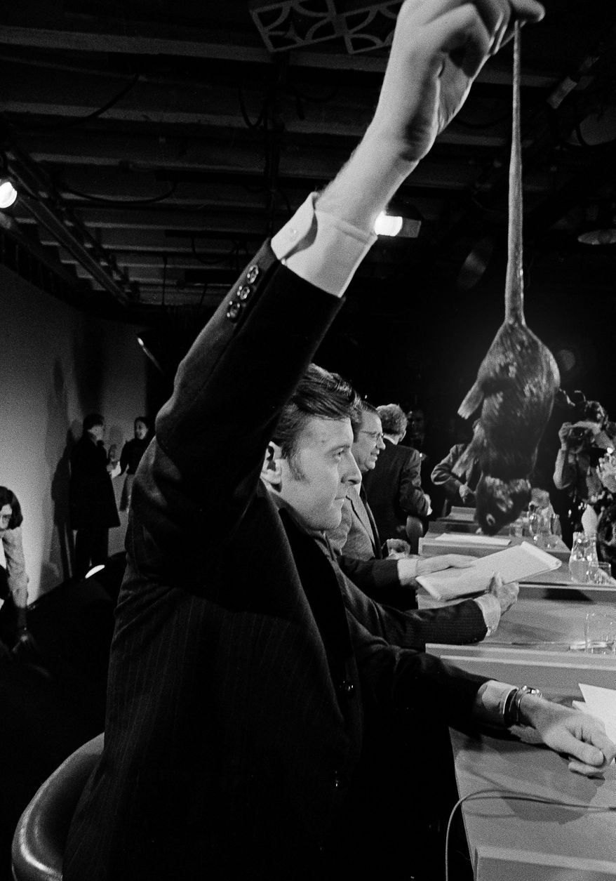 FILE- In this March 6, 1972 file photo presidential candidate Edward T. Coll of Hartford, Conn., swings a rubber rat that he used during the television debate among five Democratic presidential candidates in Durham, N.H., But 75-year-old Ned Coll, who has outlived the four other Democratic candidates he faced that night, is considering another presidential campaign. AP Photo/J. Walter Green/FILE)