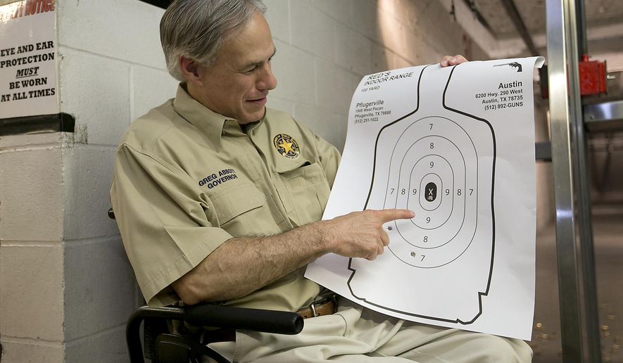 Texas Gov. Greg Abbott displays his marksmenship at Red's Indoor Range in Pfulgerville, Texas, Saturday, June 13, 2015. Abbott stopped at the gun range to sign into law bills letting Texans carry concealed handguns on college campuses and openly carry them virtually everywhere else. (Ralph Barrera/Austin American-Statesman via AP) AUSTIN CHRONICLE OUT, COMMUNITY IMPACT OUT, INTERNET AND TV MUST CREDIT PHOTOGRAPHER AND STATESMAN.COM, MAGS OUT