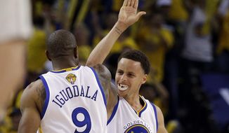 Golden State Warriors guard Stephen Curry (30) celebrates with forward Andre Iguodala (9) during the second half of Game 5 of basketball&#39;s NBA Finals against the Cleveland Cavaliers in Oakland, Calif., Sunday, June 14, 2015. (AP Photo/Ben Margot)