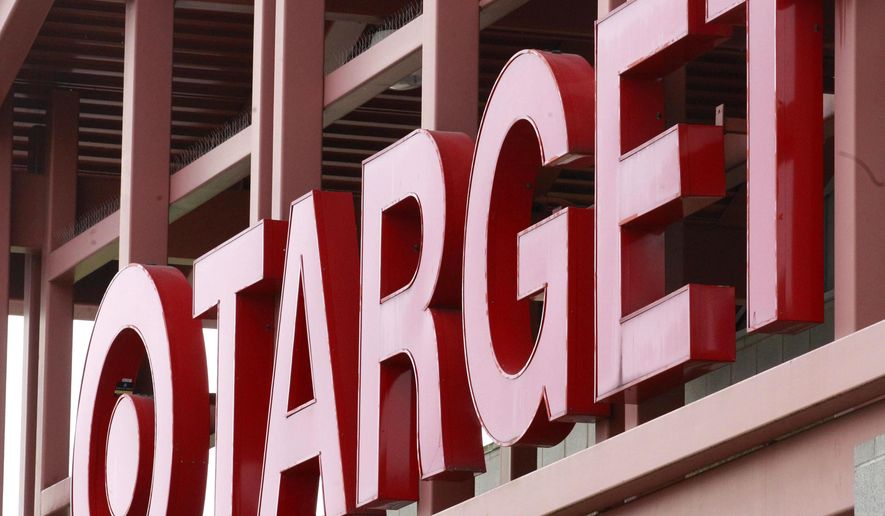 FILE - This Tuesday, May 17, 2011, file photo, shows a Target sign on the front of a Target Store, in Wilsonville, Ore. Target announced Monday, June 15, 2015, that it is selling its pharmacy and clinic businesses to the drugstore chain CVS Health for about $1.9 billion in a deal that combines the resources of two retailers seeking to polish their reputations as health care providers. (AP Photo/Rick Bowmer, File)