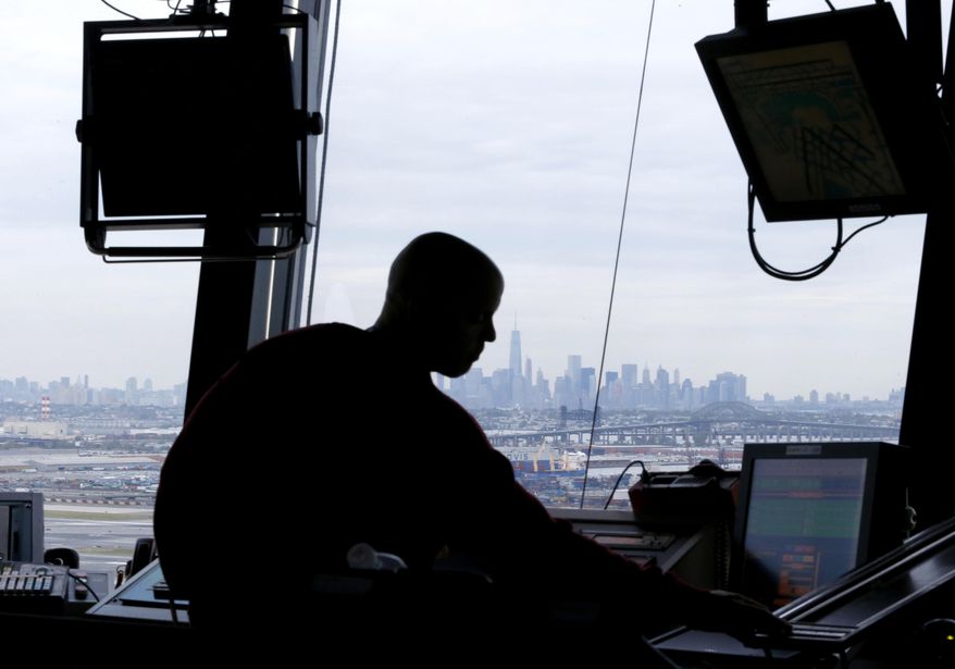 FILE - In this May 21, 2015 file photo, an air traffic controller works in the tower at Newark Liberty International Airport in Newark, N.J. The chairman of the House transportation committee says he'll introduce a bill this month that takes control of air traffic operations away from the government and places it under the control of a non-profit corporation run by airlines and other segments of the aviation industry. Rep. Bill Shuster, R-Pa.,, says keeping air traffic operations under government control would be "the surest road to failure." (AP Photo/Julio Cortez, File)