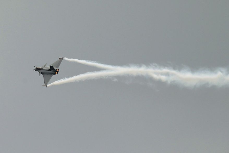 A Rafale jet fighter performs its demonstration flight during the Paris Air Show, at Le Bourget airport, north of Paris, Monday, June 15, 2015. Some 300,000 aviation professionals and spectators are expected at this week’s Paris Air Show, coming from around the world to make business deals and see dramatic displays of aeronautic prowess and the latest air and space technology. (AP Photo/Francois Mori)