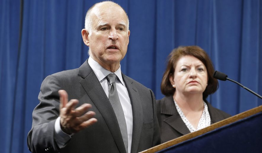 Calif., Gov. Jerry Brown answers a question concerning the budget agreement reached with legislative leaders at a Capitol news conference in Sacramento, Calif., Tuesday, June 16, 2015. Accompanied by Assembly Speaker Toni Atkins, D-San Diego, right, and Senate President Pro Tem Kevin de Leon, D-Los Angeles, unseen, Brown outlined the budget plan that send billions more to public schools and universities in the fiscal year that begins July 1. (AP Photo/Rich Pedroncelli)