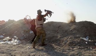 Iraqi security forces defend their positions against an Islamic State group attack in Husaybah, 8 kilometers (5 miles) east of Ramadi, Iraq, June 15, 2015. (Associated Press) ** FILE **