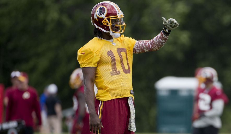 Washington Redskins quarterback Robert Griffin III gestures as he takes part in drills during an NFL football minicamp at Redskins Park Tuesday, June 16, 2015 in Ashburn, Va. (AP Photo/Pablo Martinez Monsivais)