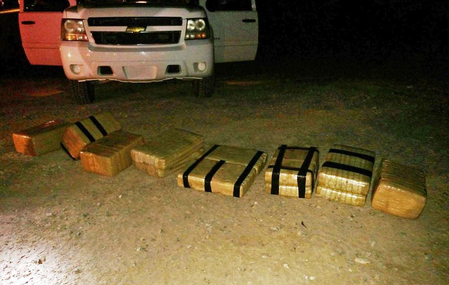 This undated photo provided by the U.S. Customs and Border Protection shows some 180 pounds of marijuana that was brought into the U.S. from Mexico aboard a go-cart, seen near Yuma, Ariz. The go-cart crossed into the United States and fled back to Mexico after unloading $90,000 worth of drugs. The incident occurred Thursday night, June 11, 2015 near Yuma and led to a Border Patrol pursuit of the smugglers. (U.S. Customs and Border Protection via AP)