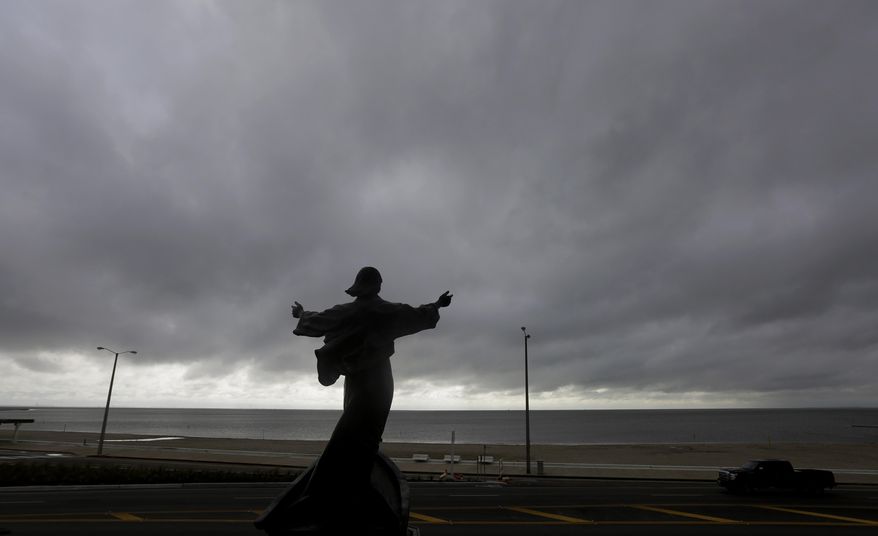 A statue of Jesus calming the sea titled "It is I" faces the bay and gulf, in Corpus Christi, Tuesday, June 16, 2015, as Tropical Storm Bill begins to make landfall. The National Hurricane Center in Miami says Tropical Storm Bill came ashore Tuesday morning in the area of Matagorda County, about 90 miles southwest of Houston. (AP Photo/Eric Gay)