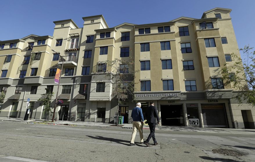 Berkeley Mayor Tom Bates, left, and Philip Grant, Consul General of Ireland of the Western United States, walk in front of a building where a balcony collapsed in Berkeley, Calif., Tuesday, June 16, 2015. Berkeley police say several people are dead and others injured after a balcony fell shortly before 1 a.m., near the University of California, Berkeley. (AP Photo/Jeff Chiu)
