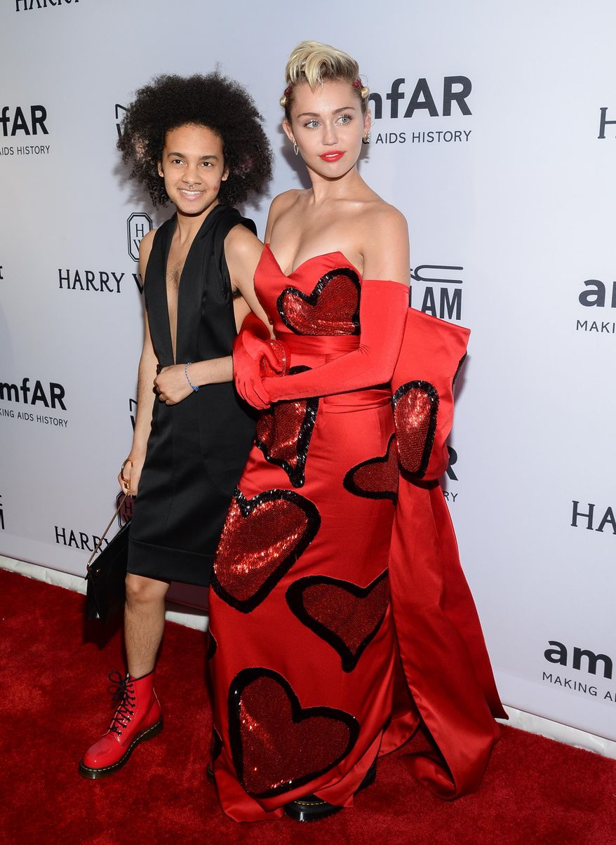 Honoree Miley Cyrus, right, arrives with friend Tyler Ford at the 6th Annual amfAR New York Inspiration Gala at Spring Studios on Tuesday, June 16, 2015, in New York. (Photo by Evan Agostini/Invision/AP)