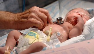 Dr. Shelley Korones listens to an infant&#39;s heart in the NICU at the Regional Medical Center in Memphis, Tenn. (Associated Press)