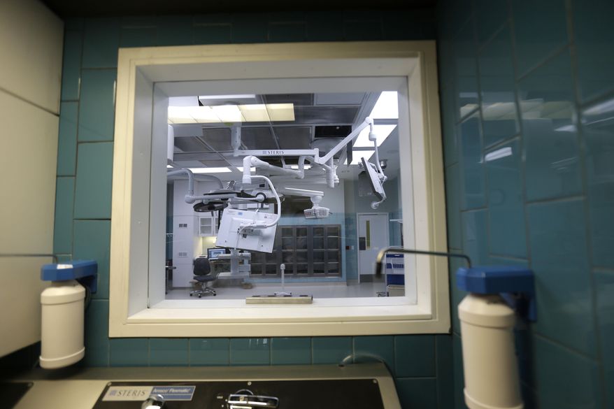 An operating room is seen through a window at a sanitizing station in the soon to open University Medical Center New Orleans, during a media tour in New Orleans, Wednesday, June 17, 2015. (AP Photo/Gerald Herbert)