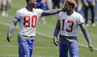 New York Giants wide receiver Victor Cruz (80) and Odell Beckham (13) walk on the field during NFL football mini camp, Wednesday, June 17, 2015, in East Rutherford, N.J.  (AP Photo/Frank Franklin II)