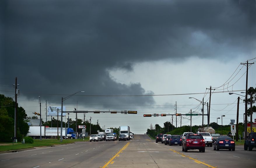 Ominous low-hanging clouds accompanied a thunderstorm from the outer bands of Tropical Storm Bill that was already reaching north Texas as this cell passed over East University Drive Tuesday, June 16, 2015, in Denton, Texas. (Al Key/The Denton Record-Chronicle via AP)