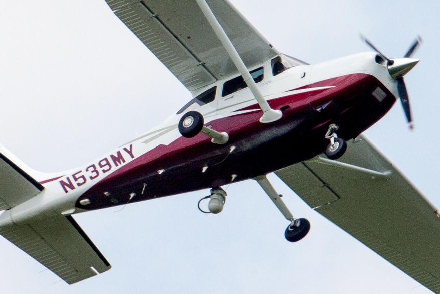 FILE - In this May 26, 2015, file photo, a small plane flies near Manassas Regional Airport in Manassas, Va. The plane is among a fleet of surveillance aircraft by the FBI, which are primarily used to target suspects under federal investigation. The FBI assured Congress on June 17, in an unusual, confidential briefing that its plane surveillance program is a by-the-books operation short on high-definition cameras, with some planes equipped with binoculars. (AP Photo/Andrew Harnik)