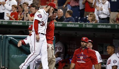 Washington Nationals right fielder Bryce Harper (34) leaves the field with head athletic trainer Lee Kuntz, rear, during the sixth inning of Thursday night&#39;s game against the Tampa Bay Rays at Nationals Park in Washington. (Associated Press)