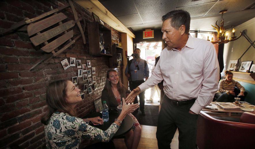 Ohio Gov. John Kasich shakes hands with customers during a walking tour of downtown Manchester, N.H., on Wednesday, June 17, 2015. Kasich is considering joining the field seeking the Republican nomination for president as he visits the nation&#39;s earliest presidential primary state. (AP Photo/Jim Cole) ** FILE **