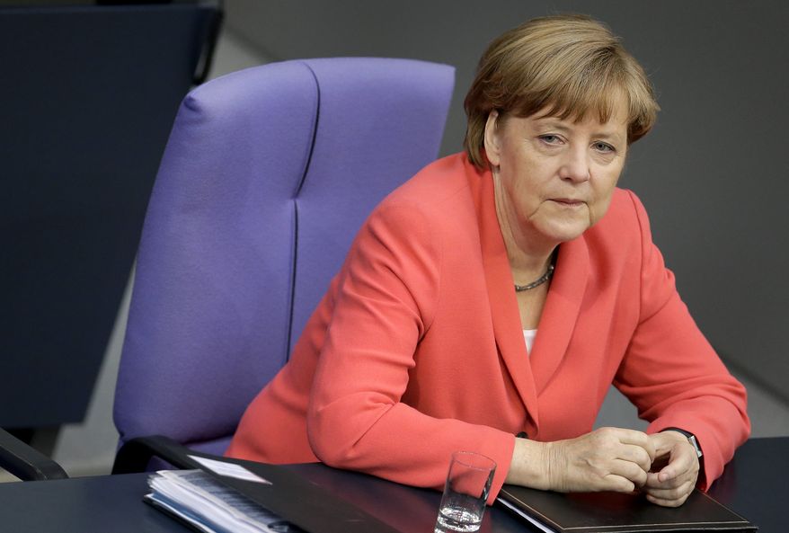 German Chancellor Angela Merkel listens to a debate of the German federal parliament, Bundestag, in Berlin, Germany, Thursday, June 18, 2015. (AP Photo/Michael Sohn) ** FILE **