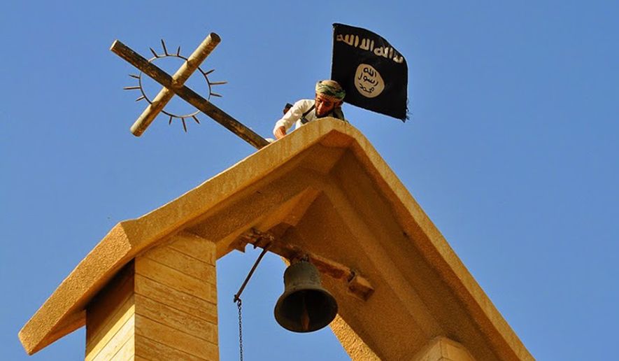 In this photo released on March 7, 2015 by a militant website, which has been verified and is consistent with other AP reporting, a member of the Islamic State group holds the IS flag as he dismantles a cross on the top of a church in Mosul, Iraq. (Militant website via AP)
