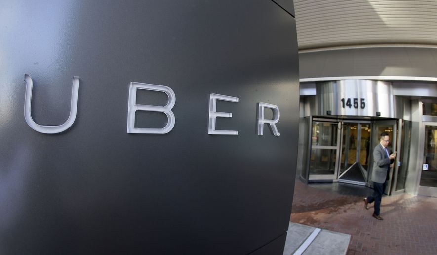In this photo taken Tuesday, Dec. 16, 2014, a man leaves the headquarters of Uber in San Francisco. (AP Photo/Eric Risberg, File)