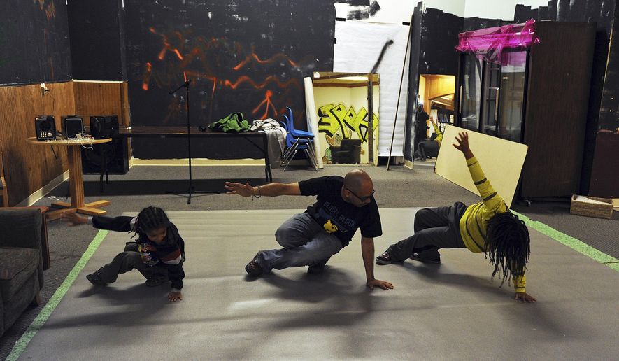 ADVANCE FOR SATURDAY JUNE 20, 2015 AND THEREAFTER In this photo taken June 5, 2015, George Martinez, center, teaches the six step, a series of foundational moves for breakdancing, at his space in a mall in Anchorage, Alaska. Until recently, this mall space was empty, stacked up with old furniture and used as a haunted house at Halloween. This summer, Martinez wants to transform it into something Anchorage doesn’t have: A center for urban arts education and hip-hop culture. (Erik Hill/Alaska Dispatch News via AP)