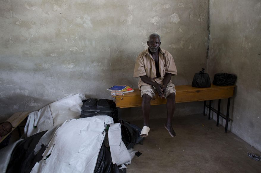Andre Joseph, 53, who says he was born in the Dominican Republic and lived there until being deported the day before, sits inside a school classroom where residents have allowed him and other deportees to sleep in the village of Fonbaya, Haiti, Thursday, June 18, 2015. Thousands of people began preparing Thursday for deportation from the Dominican Republic after failing to obtain legal residency as part of a government program to crack down on migrants, most of them from neighboring Haiti or of Haitian descent. (AP Photo/Rebecca Blackwell)