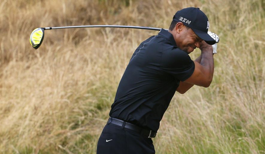 Tiger Woods reacts to his tee shot on the eighth hole during the first round of the U.S. Open golf tournament at Chambers Bay on Thursday, June 18, 2015 in University Place, Wash. (AP Photo/Matt York)