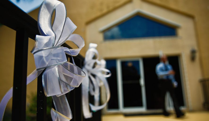 Mourners placed ribbons in memory of the nine people killed at the Emmanuel AME Church in Charleston, South Carolina, last Wednesday. The incident has renewed passions on all sides of the debate on gun rights and concealed carry laws. (associated press)