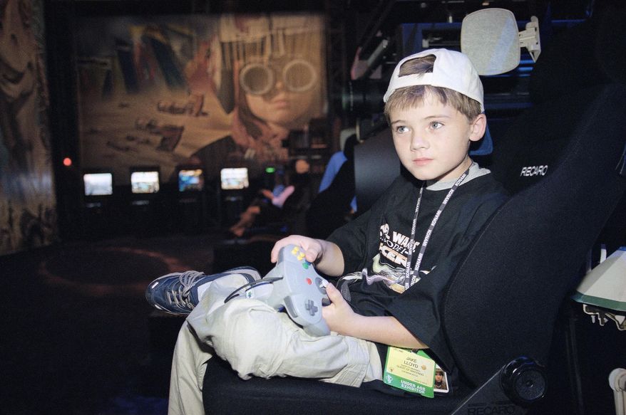 FILE- In this May 13, 1999, file photo, actor Jake Lloyd; who portrays young Anakin Skywalker in the film "Star Wars Episode I: The Phantom Menace;" plays a game during the Electronic Entertainment Expo in Los Angeles. Colleton County Sheriff’s Sgt. Kyle Strickland said Sunday, June 21, 2015, that deputies on Wednesday arrested a 26-year-old man they confirmed through a former talent agent Lloyd. Lloyd faces charges after leading South Carolina deputies on a high-speed chase. (AP Photo/Kevork Djansezian, File)