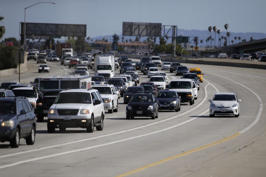 ADVANCE FOR USE FRIDAY, JUNE 26, 2014 AND THEREAFTER - In this Saturday, May 16, 2015 photo, a car travels along one of the "ExpressLanes" to avoid heavy traffic on the northbound 110 Freeway during afternoon rush hour in Los Angeles. With a special transponder, solo drivers can choose to pay to access the lane, and carpools can use it toll free. (AP Photo/Jae C. Hong)