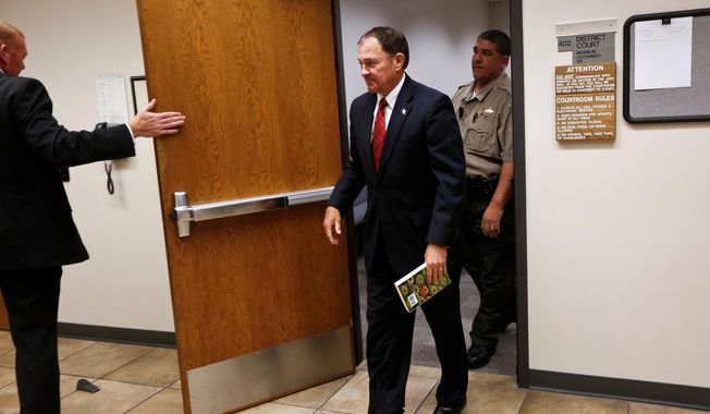 Utah Gov. Gary Herbert leaves a courtroom at the Fourth District Court, Tuesday, June 23, 2015, in Provo, Utah. A judge has dismissed Mr. Herbert from serving on a jury after the Republican governor reported to court. (Spenser Heaps/The Daily Herald via AP)