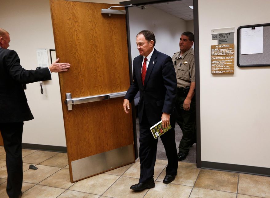 Utah Gov. Gary Herbert leaves a courtroom at the Fourth District Court, Tuesday, June 23, 2015, in Provo, Utah. A judge has dismissed Mr. Herbert from serving on a jury after the Republican governor reported to court. (Spenser Heaps/The Daily Herald via AP)