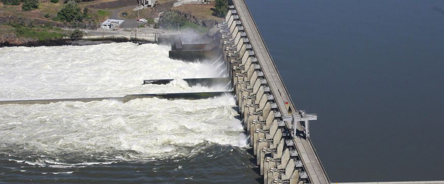 FILE - This June 3, 2011, file photo shows the Dalles Dam in the Columbia River, in Dalles, Ore. Federal authorities defended Tuesday, June 23, 2015, their latest plan for mitigating damage to salmon and steelhead imperiled by hydroelectric dams in the Columbia River Basin. (AP Photo/Rick Bowmer, File)