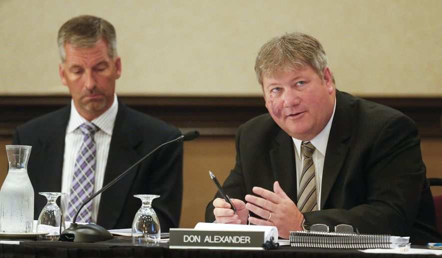 The Kansas State Lottery Gaming Facility Review Board's Don Alexander, right, alongside Jeff Oakes, asks questions of a consultant on Tuesday June 23, 2015, at the Downtown Ramada Hotel and Convention Center in Topeka, Kan., before hearing three proposals for the construction of a casino in Southeast Kan. (Chris Neal/Topeka Capital-Journal via AP)