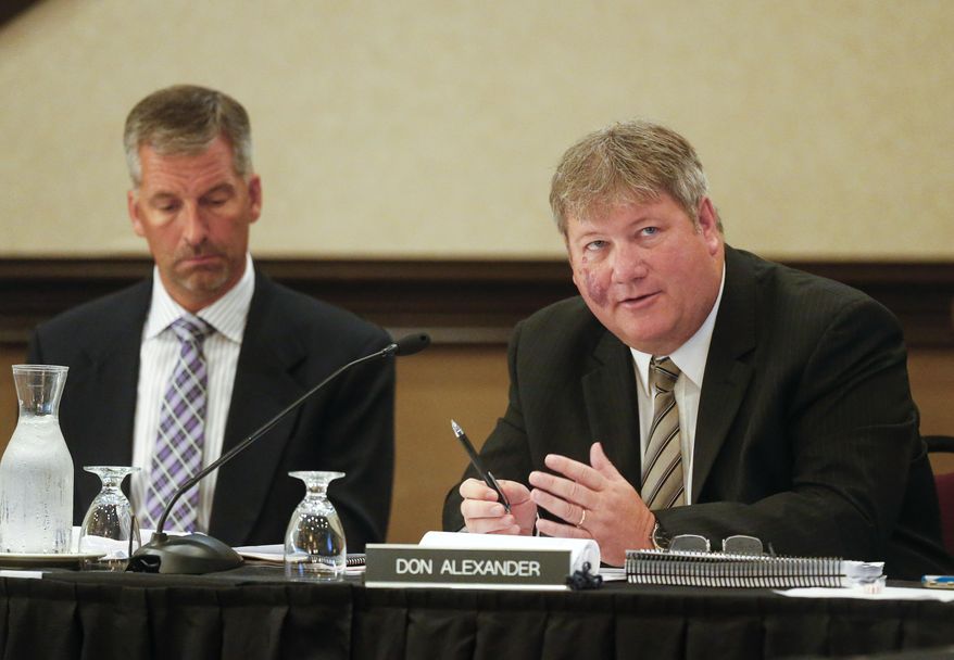 The Kansas State Lottery Gaming Facility Review Board's Don Alexander, right, alongside Jeff Oakes, asks questions of a consultant on Tuesday June 23, 2015, at the Downtown Ramada Hotel and Convention Center in Topeka, Kan., before hearing three proposals for the construction of a casino in Southeast Kan. (Chris Neal/Topeka Capital-Journal via AP)