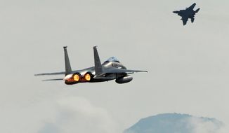 A pair of F-15C Eagles from the 18th Wing at Kadena Air Base, in Japan, take off from Joint Base Elmendorf-Richardson near Anchorage, Alaska, Tuesday, June 23, 2015, while participating in Northern Edge, a joint training exercise. (Bill Roth/Alaska Dispatch News via AP) ** FILE **
