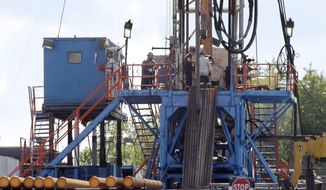  In this June 25, 2012, file photo, a crew works on a gas drilling rig at a well site for shale based natural gas in Zelienople, Pa. (AP Photo/Keith Srakocic, File)